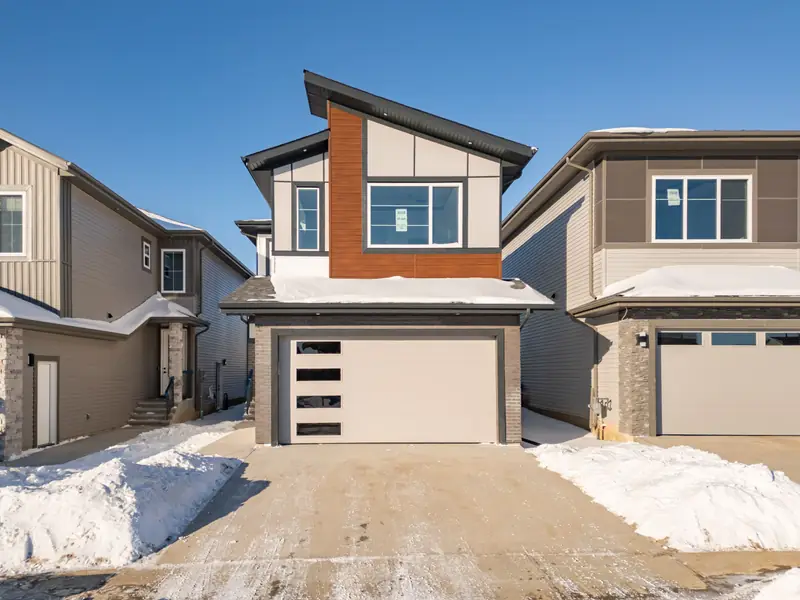 The front of a finished Vita home in Triomphe Estates (winter 2026).
