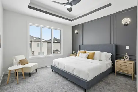 The primary bedroom. Furniture and décor are staging for the photos.